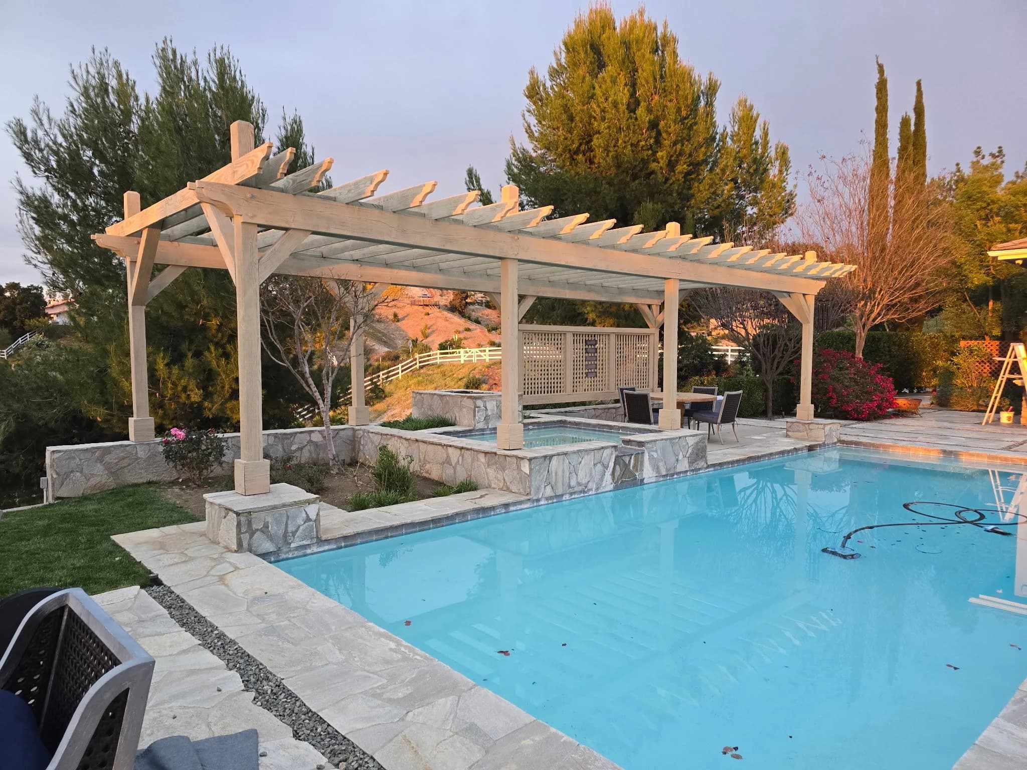 Finished pergola over poolside at sunset
