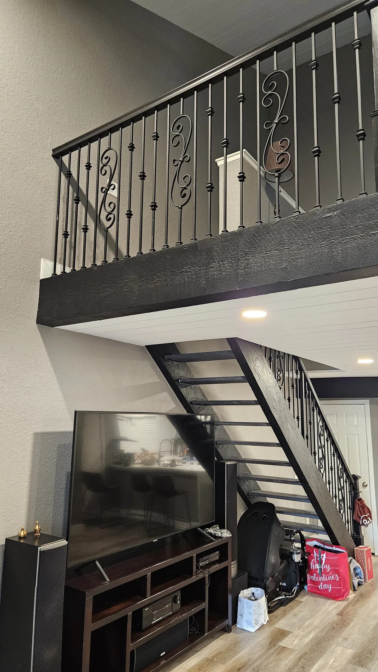 Custom black-painted staircase railing and rod-iron detail